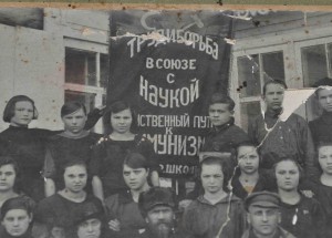 Группа на фоне флага Труд и Борьба в союзе с наукой !