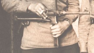 С трофейным оружием.