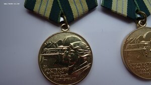 Две медали БАМ с удостоверением на мужа и жену.